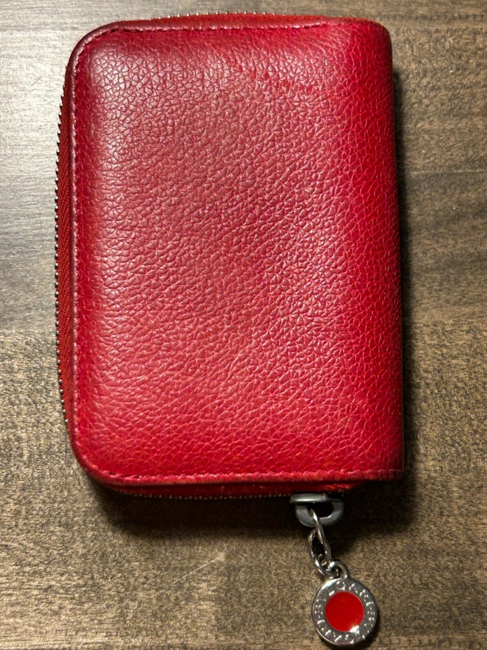 Bvlgari Red Leather Zip Wallet with Signature Charm. Used condition.
